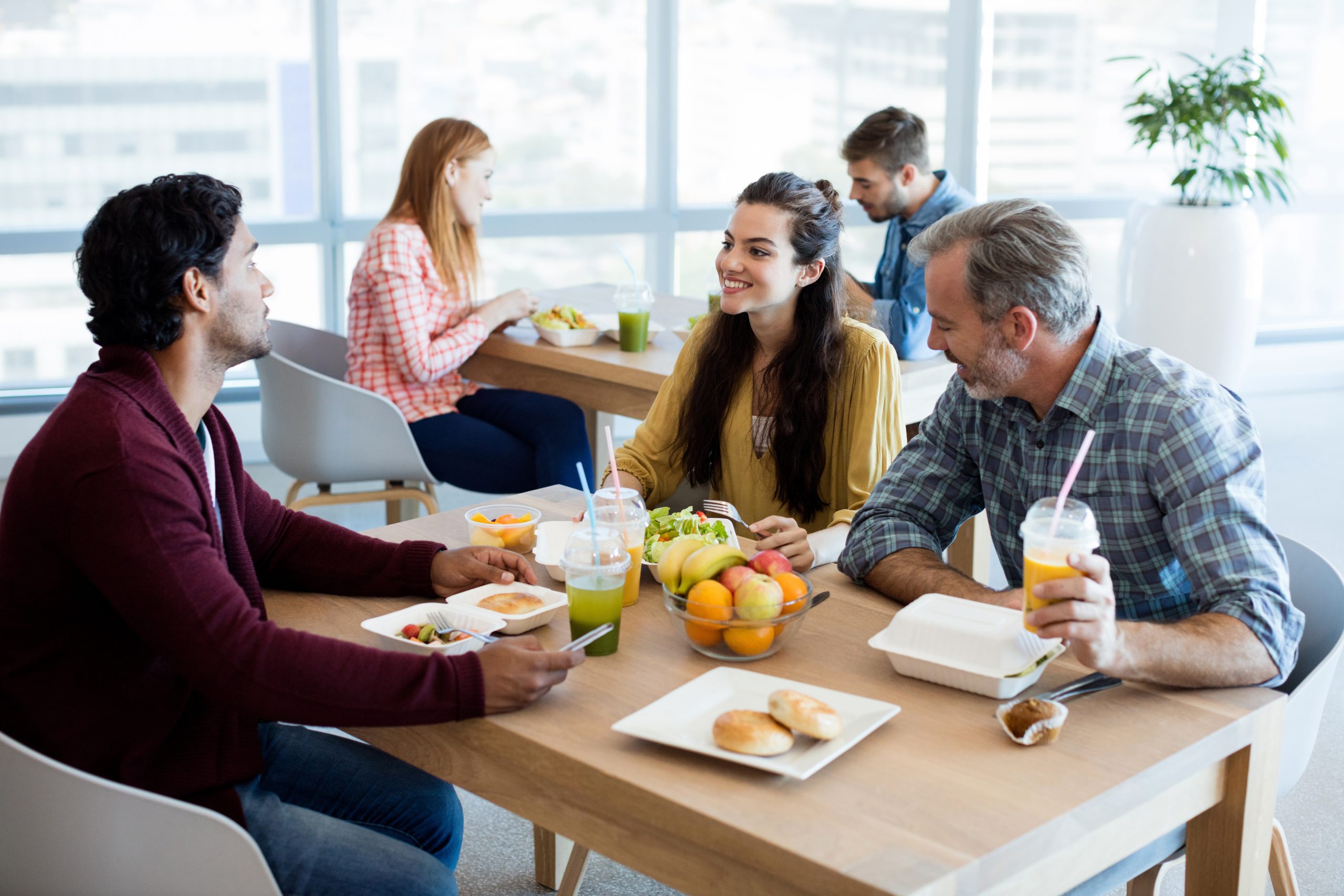 creative-business-team-discussing-while-having-meal