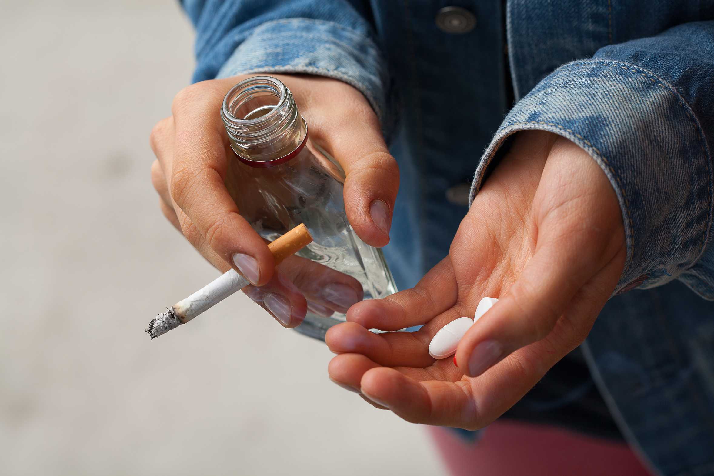 girl-holding-vodkapills-and-cigarettes