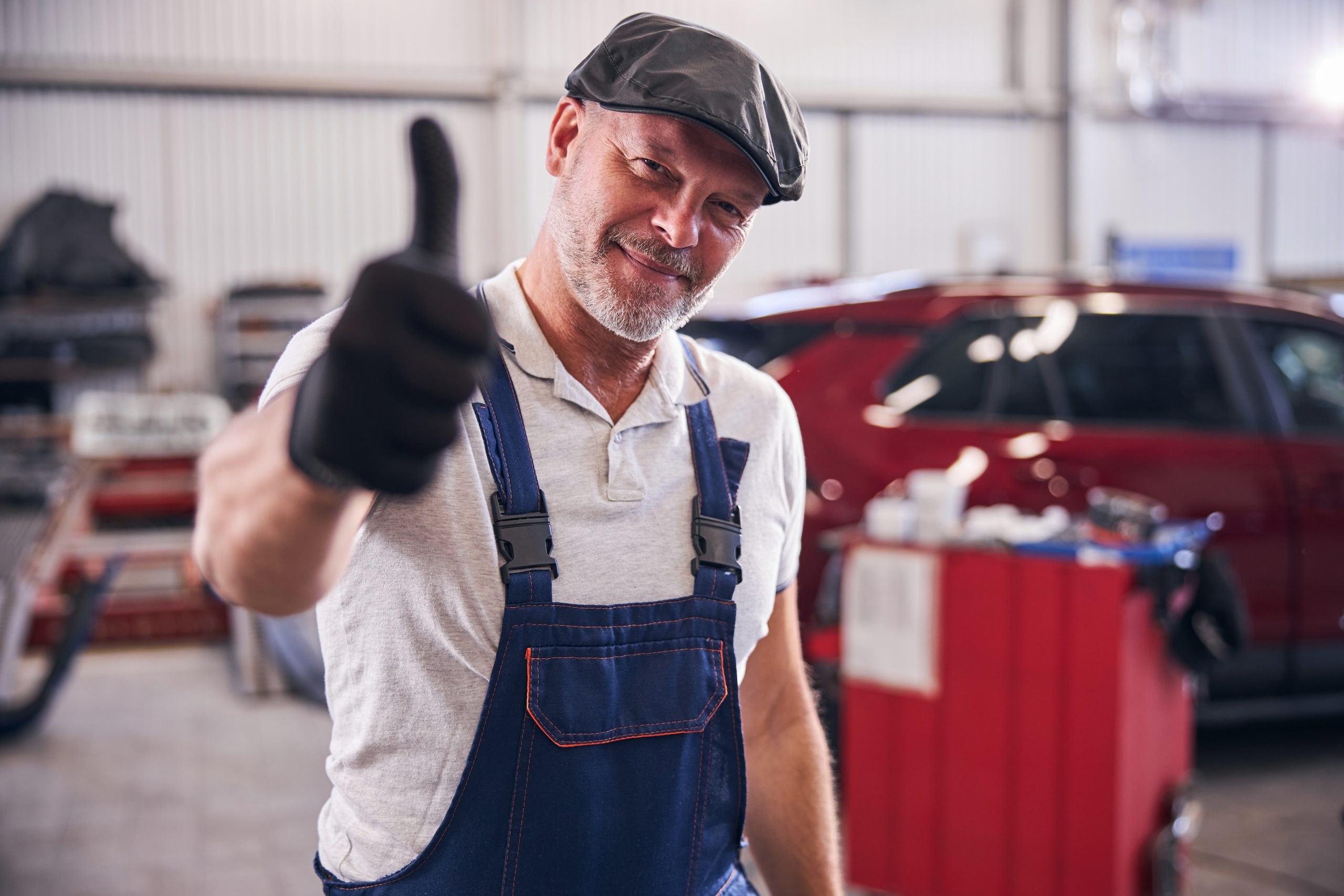 handsome-mechanic-giving-thumbs-up-and-smiling